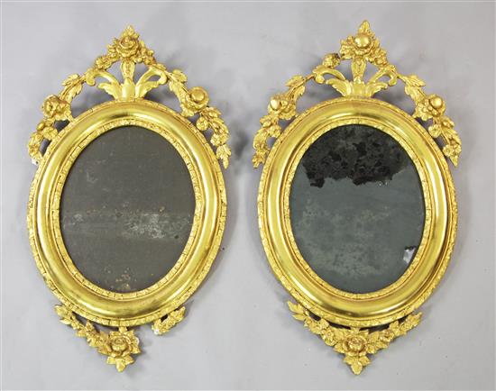 A pair of 19th century gilt oval wall mirrors, 2ft 5.5in. x 1ft 5.5in.